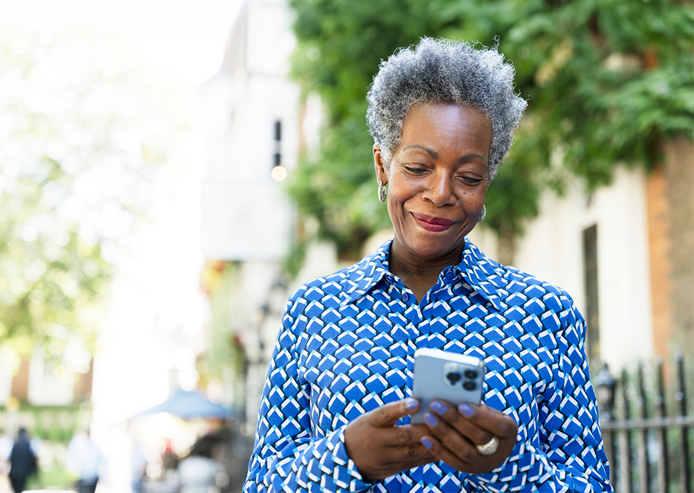 Older African-American woman looking at her phone